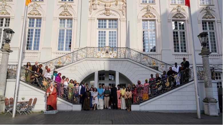 Delegates proudly display their national costumes in front of the historic Town Hall in Bonn, symbolizing the global commitment to sustainable land management