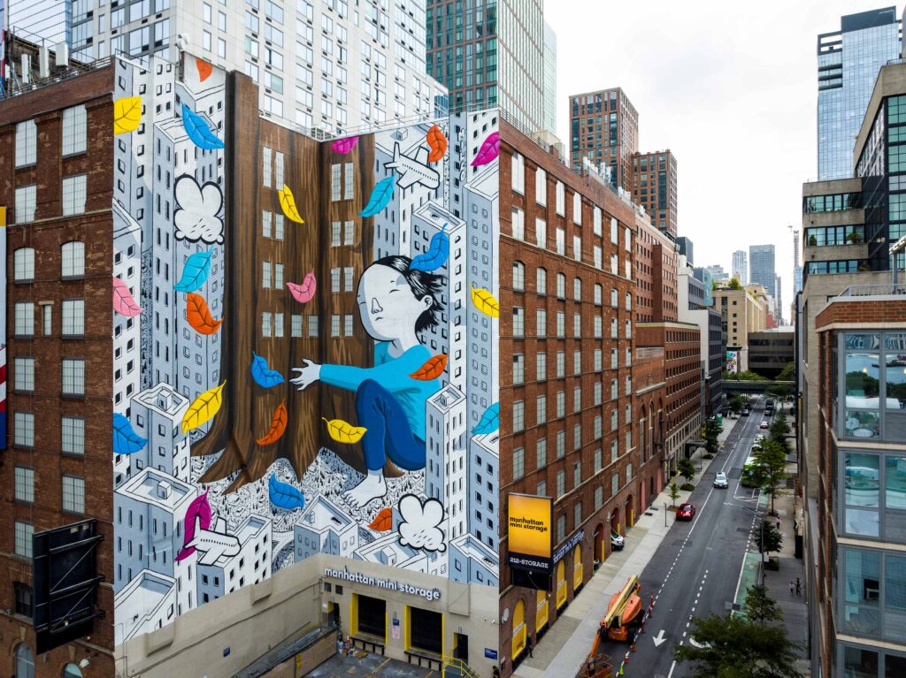 A giant mural of a child hugging trees in New York City