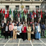 Participants at the Biosaline Agriculture as an approach to land restoration in the Arab world, in Cairo, Egypt, pose in front of flags