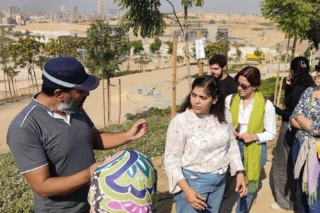 A university professor with workshop participants at a garden, in Al-Fustat, in Cairo, Egypt