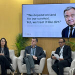 A presenter standing in front of an audience, with other panel members at the background, during an event at the Restoration Pavilion, on 4 December 2024, in Riyadh, Saudi Arabia