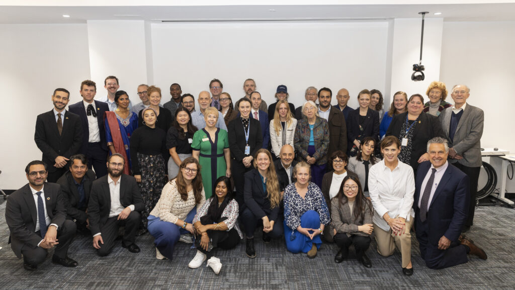 A group of people, smiling and posing for camera