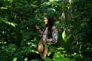 A woman explaining in rain forest