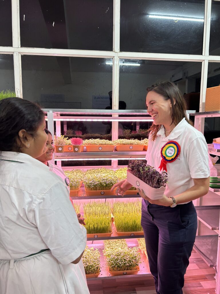 A woman looking at herbs at a lab