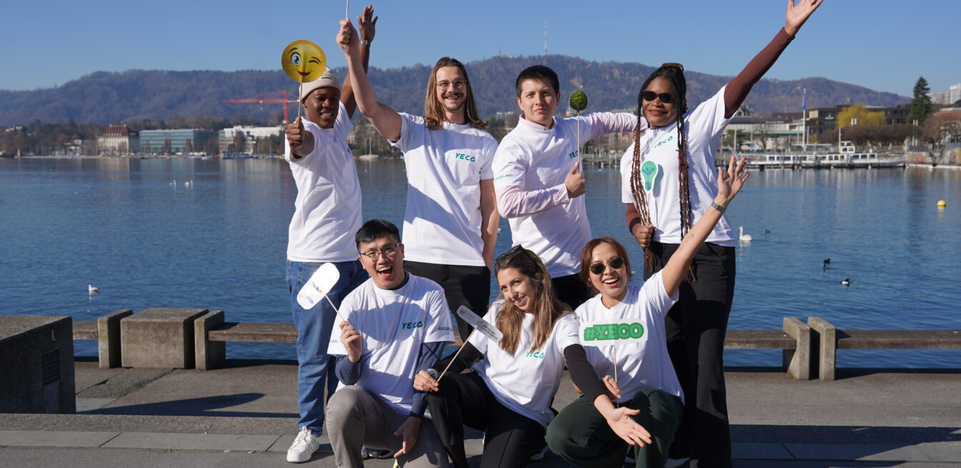 Group of young men and women holding signs and raising hands by Lake Zurich in Switzerland