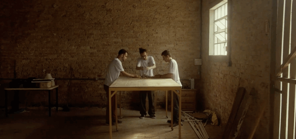 Three people at a table, working