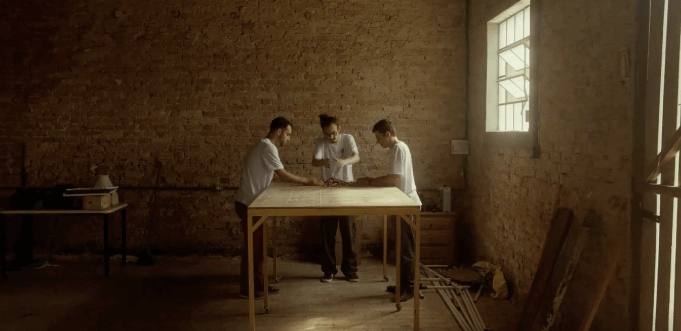 Three people at a table, working