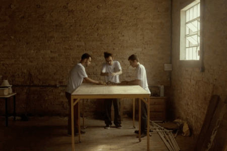 Three people at a table, working