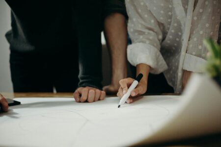 Two people study on paper