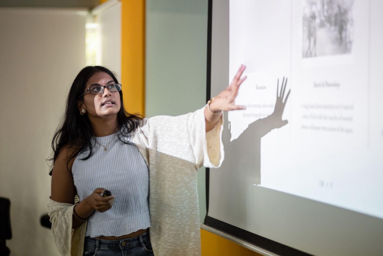 A woman instructor against a whiteboard