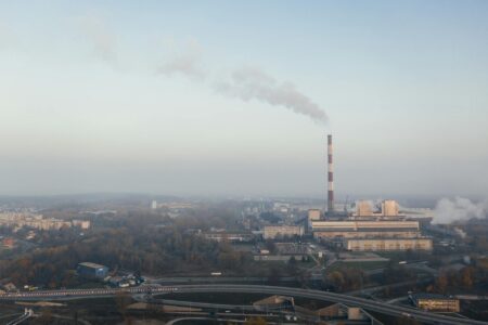 A factory's chimney exudes smoke in Poznan, Poland