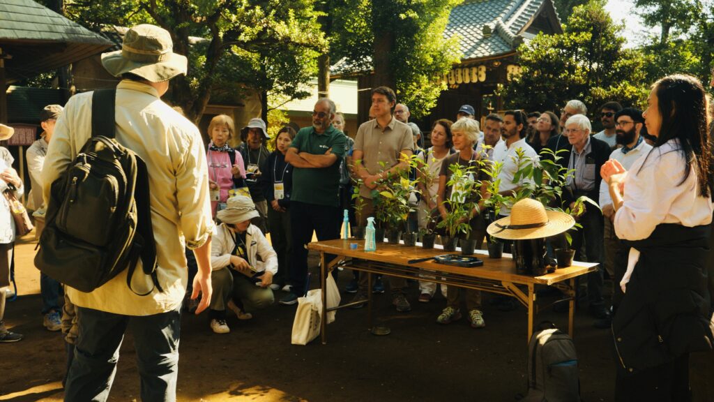Group of participants at a Miyawaki Forest Symposium in a garden