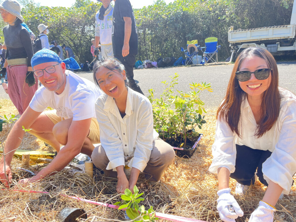 Joann Lee from UNCCD G20 Global Land Initiative with two others, planting trees